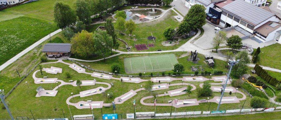 Find your accommodation in South Tyrol Aerial view of a miniature golf course and nearby buildings in a village
