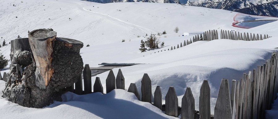 Find your accommodation in South Tyrol Snow-covered fence with mountain view in winter